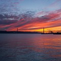 As cores do pôr-do-sol, projetadas nas nuvens acima da ponte 25 de abril, esta tarde